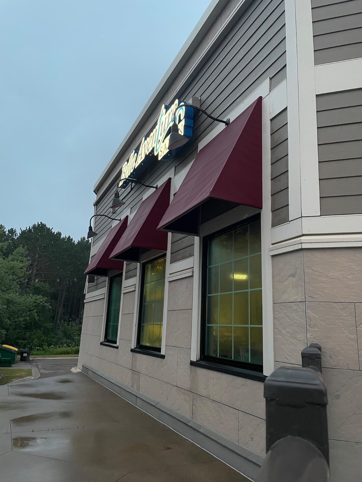Salon storefront with freshly cleaned burgundy awnings and siding in Hermantown, Minnesota
